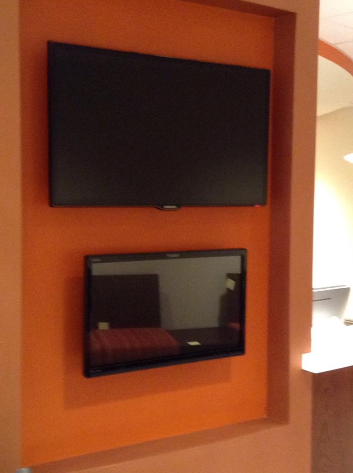 Image of two televisions on the wall